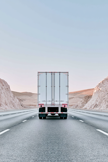 Desert Highway with White Box Trailer Truck