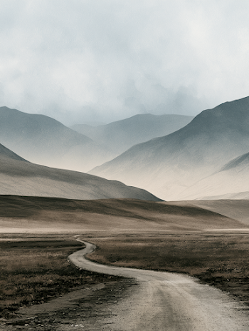 Desolate Mountain Landscape Under Gloomy Sky