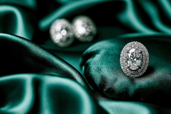 Elegant Oval Diamond Stud Earrings on Emerald Silk