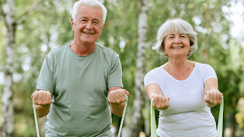 Happy Senior Couple Exercising Outdoors
