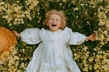 Joyful Little Girl in a Meadow of Wildflowers
