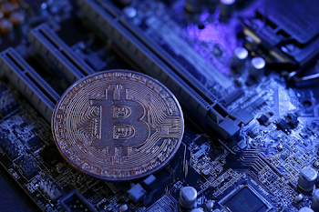 Macro Close-Up of a Bitcoin Coin on a Dark Motherboard