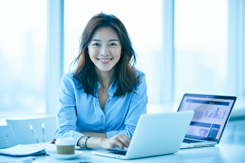 Smiling Asian Female Accountant in Modern Office