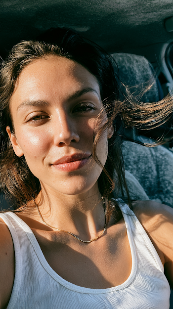 Sunlit Portrait of a Young Woman in a Car