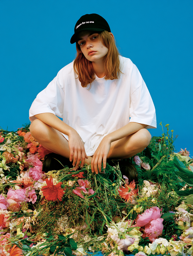 Casual Elegance: Young Woman Among Fresh Flowers