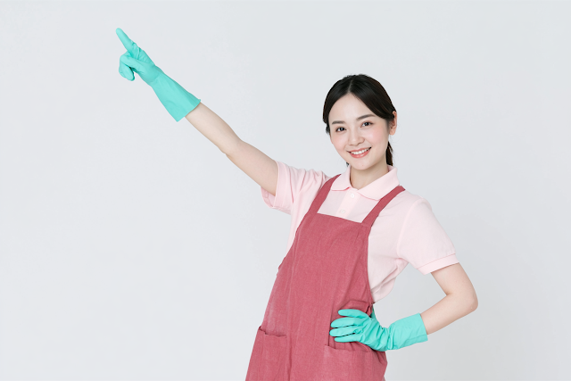 Cheerful Asian Woman Cleaning Worker in a Studio