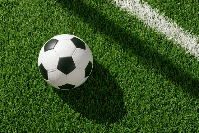 Classic Black and White Soccer Ball on Green Turf