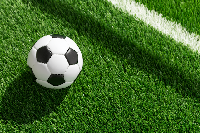 Classic Black and White Soccer Ball on Green Turf