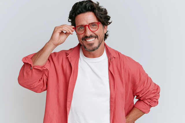 Confident Middle-Aged Man Adjusting Glasses
