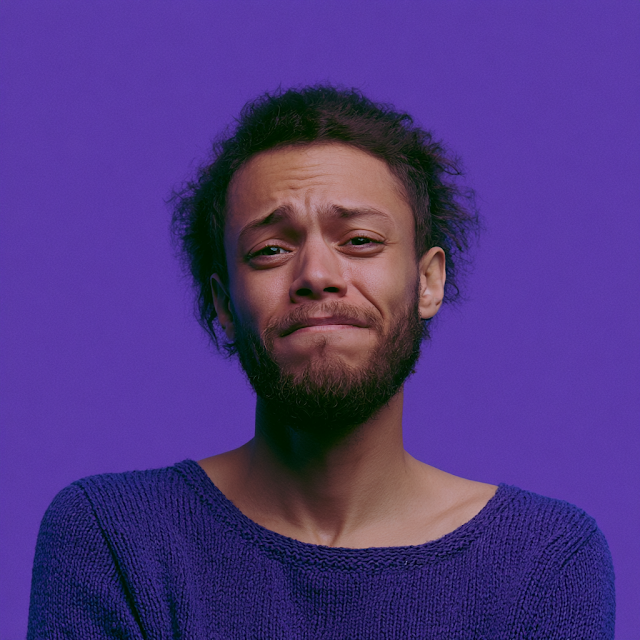 Contemplative Young Man with Purple Background