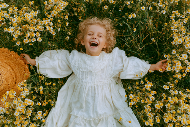 Joyful Little Girl in a Meadow of Wildflowers