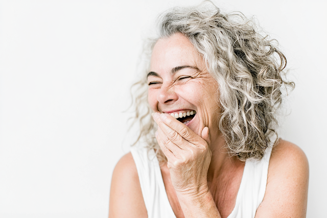 Joyful Middle-Aged Woman Laughing in Studio Portrait