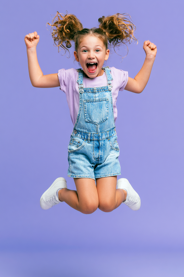 Joyful Young Girl Jumping with Happiness