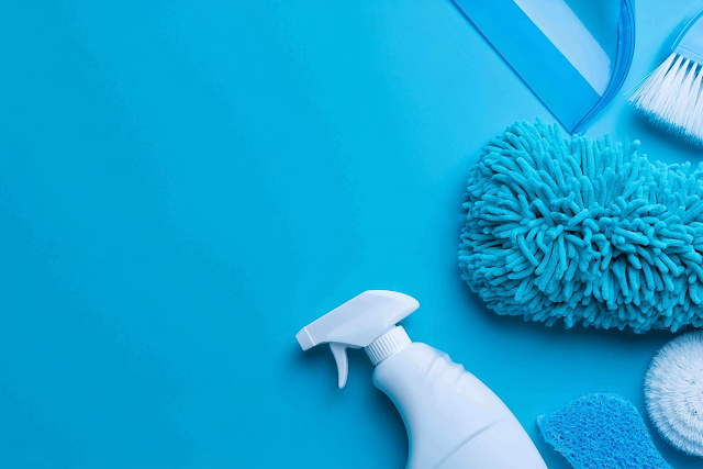 Overhead Flat Lay of Household Cleaning Supplies on Cyan Blue Surface