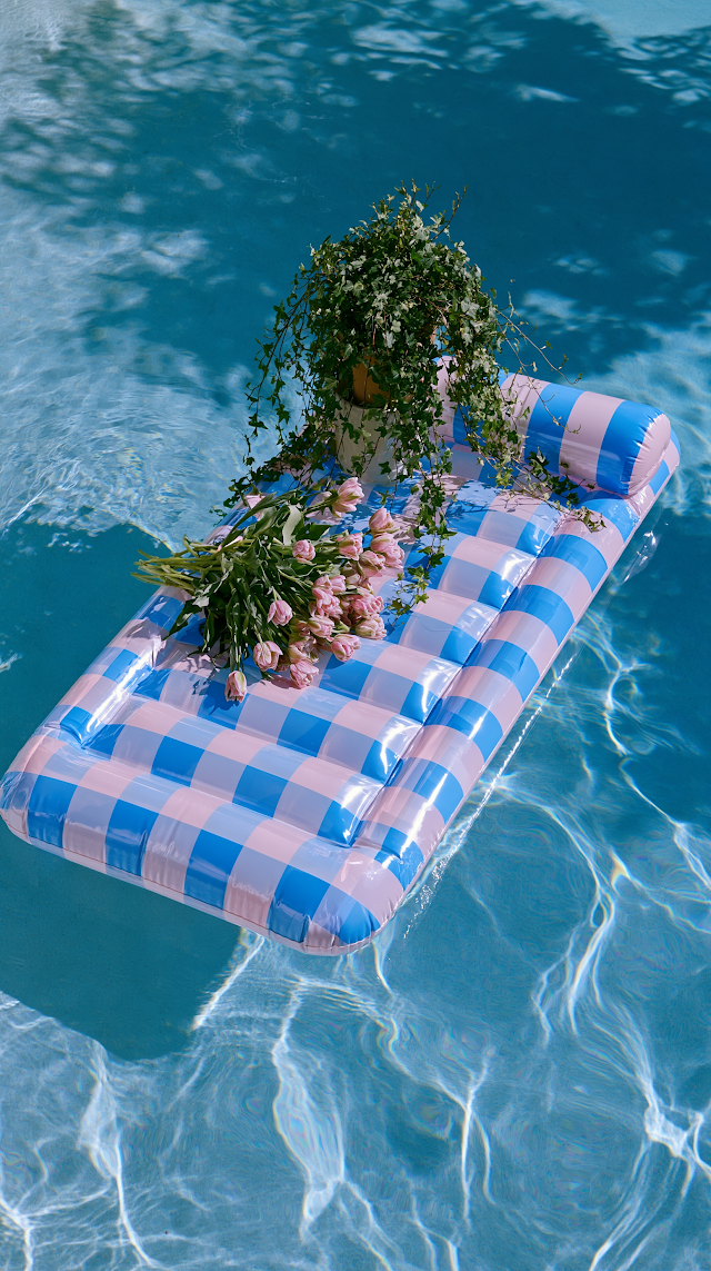 Relaxing Summer Vibes: Inflatable Mattress in a Blue Pool