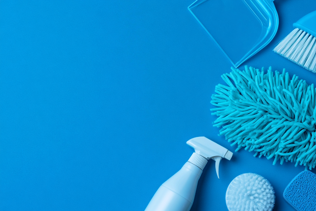 Vibrant Household Cleaning Supplies on Cyan Surface